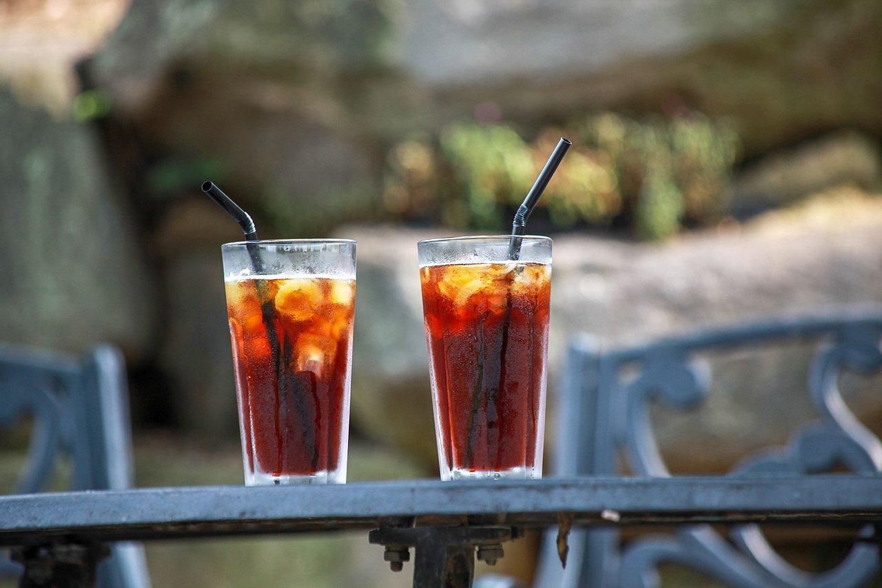 Five viral Korean cafe drinks lined up on a cafe table in Seoul summer 2026, including strawberry latte and yuzu ade