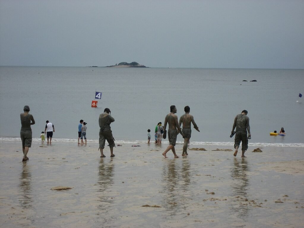 Visitors covered in mud at the Boryeong Mud Festival