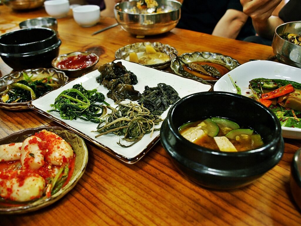 Korean meal with banchan side dishes and doenjang jjigae
