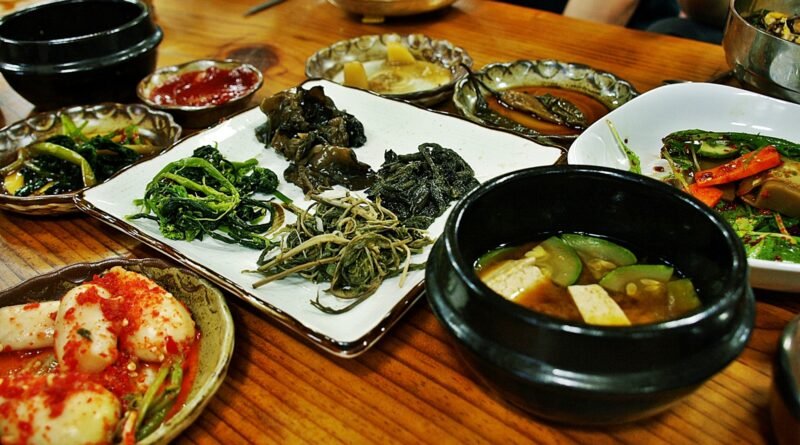 Korean meal with banchan side dishes and doenjang jjigae